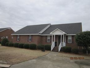 Wilson apartment for rent - A house with a grey roof and a white door.