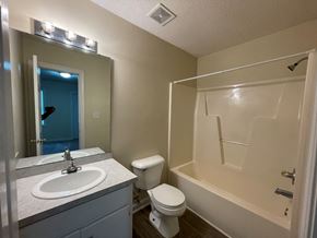 Wilson apartment for rent - A bathroom with a sink, toilet, and bathtub.