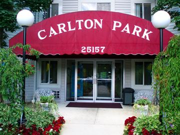 North Olmsted apartment for rent - the entrance to the carillon park building with a red awning