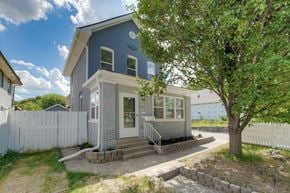 Indianapolis house for rent - a blue and white house with a tree in front of it