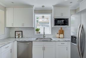 Indianapolis house for rent - a white kitchen with white cabinets and a sink