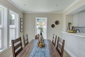 Indianapolis house for rent - a dining room with a wooden table and chairs