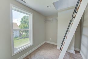 Indianapolis house for rent - a bedroom with a large window and a ladder in the corner