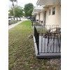 North Miami Beach apartment for rent - A black metal fence with a gate is in front of a house.