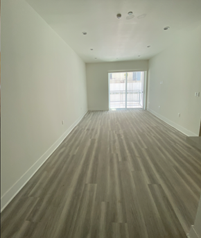 North Hollywood apartment for rent - an empty living room with wooden floors and a window