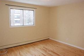 Edmonton apartment for rent - A room with a window and wooden flooring.