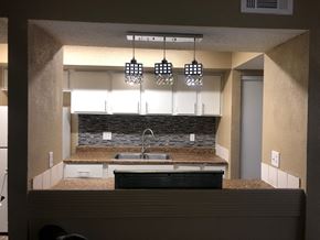 Las Vegas apartment for rent - a kitchen with white cabinets and a counter top