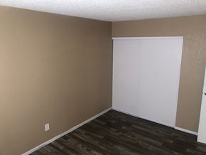 Las Vegas apartment for rent - an empty room with a wood floor and a white closet