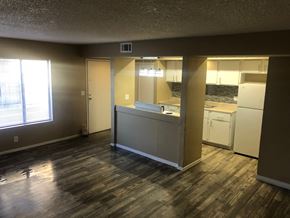 Las Vegas apartment for rent - an empty living room with a kitchen and a window