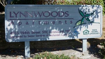 Lynnwood apartment for rent - a sign apartments is shown in front of trees