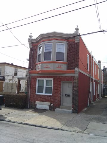 Philadelphia apartment for rent - A red brick house with a white door and windows.
