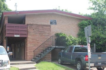 Houston apartment for rent - a building with a truck parked outside of it