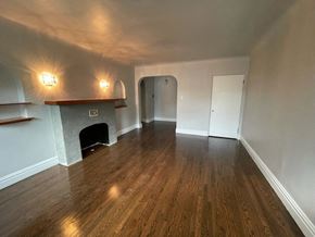Chicago apartment for rent - A room with a fireplace and wood flooring.
