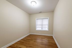 Chicago apartment for rent - A room with a window and wooden flooring.