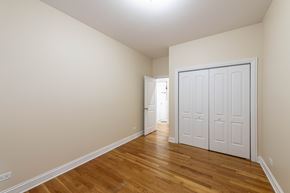 Chicago apartment for rent - A room with a white door and wooden flooring.