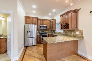 Chicago apartment for rent - A kitchen with wooden cabinets and granite countertops.