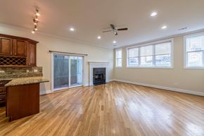 Chicago apartment for rent - A spacious living room with a fireplace and hardwood floors.