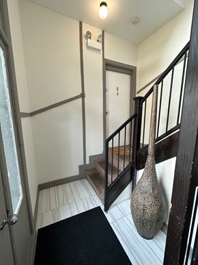 Chicago apartment for rent - a stairwell in a home with a vase on the floor