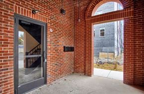 St. Louis apartment for rent - the entrance to a brick building with a glass door