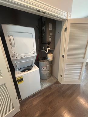 St. Louis apartment for rent - A white washing machine is in a small space between a wall and a door.