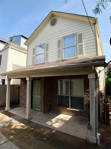 Houston house for rent - a white house with a porch and a driveway