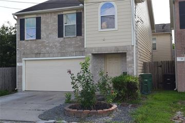 Houston house for rent - a white brick house with a garage and a driveway