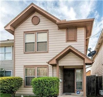 Houston house for rent - A house with a brown roof and a black door.