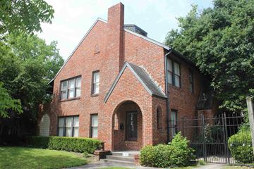 Houston apartment for rent - a red brick house with a black fence