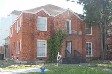 Houston apartment for rent - a fire hydrant in front of a brick house