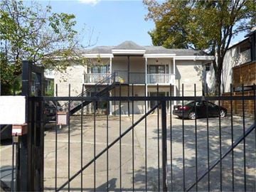 Houston apartment for rent - a house with a fence and a car parked in front of it