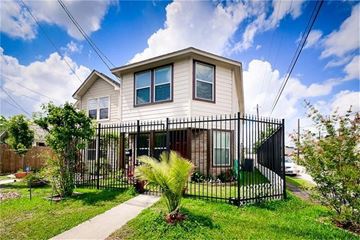 Houston house for rent - a house with a yard and a fence in front of it