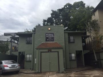 Houston apartment for rent - the front of a green building with a green garage door