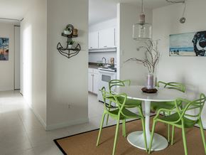 Gatineau apartment for rent - a kitchen and dining room with green chairs and a white table