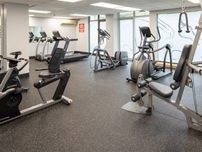 Gatineau apartment for rent - a gym with cardio equipment and weights on the floor