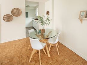 Ottawa apartment for rent - a dining room with a glass table and white chairs