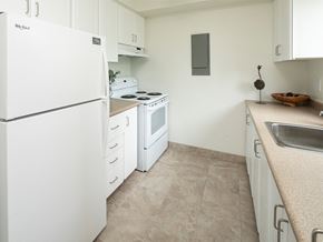 Ottawa apartment for rent - a kitchen with white appliances and a sink and a refrigerator