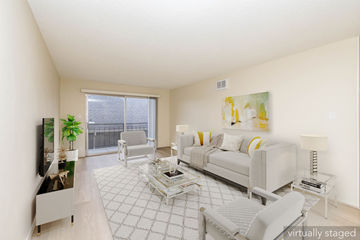 Oakland apartment for rent - A living room with a white couch and a television.