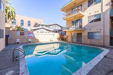 Oakland apartment for rent - A swimming pool in a courtyard surrounded by buildings.