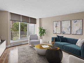 Ottawa apartment for rent - a living room with a blue couch and a round coffee table