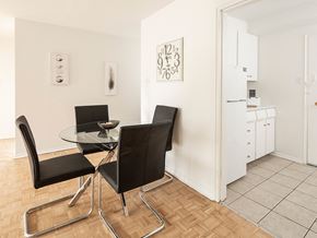 Ottawa apartment for rent - a dining room with a glass table and chairs