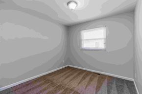 Florissant house for rent - A room with a window and a skylight.