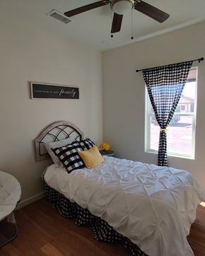 Edinburg apartment for rent - a bedroom with a bed and a window and a ceiling fan