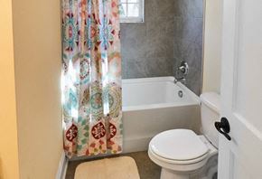 Lexington apartment for rent - A white toilet sits next to a bathtub in a bathroom.