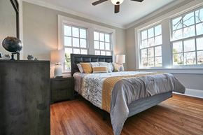 Lexington apartment for rent - A bedroom with a bed, nightstand, and a ceiling fan.