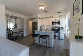 Oshawa apartment for rent - an open kitchen and dining area with a table and chairs