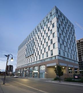 Oshawa apartment for rent - a tall building with a street in front of it