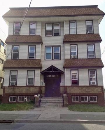 Irvington apartment for rent - a white house with a purple door on a street