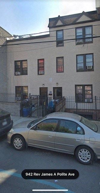 The Bronx apartment for rent - A car is parked in front of a building with the address 942 Rev James A Polite Ave.