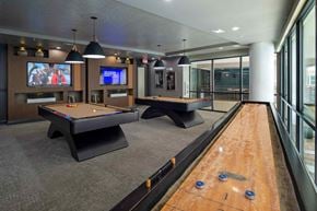 Houston apartment for rent - A room with a pool table and a TV screen.
