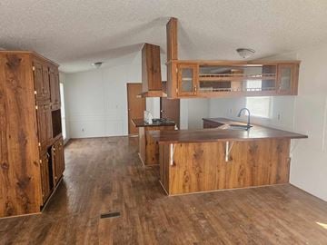Shawnee house for rent - A kitchen with wooden cabinets and a countertop.